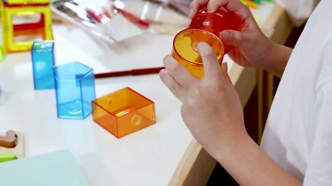 Child Assembling Colorful Geometric Shapes for Math Learning Stock Footage 320090763