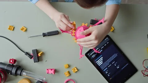 Child Assembling Robot Toy with Screwdriver in Robotics Lesson Stock Footage 339190766