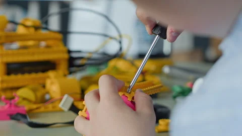 Child Assembling Robotic Toy with Screwdriver in Stem Class Stock Footage 339192235
