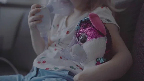 Child with asthma problems making inhalation with mask on face Stock Footage 127564424