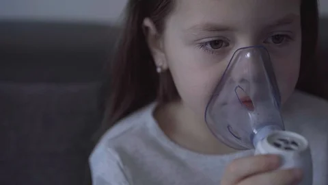 Child with asthma problems making inhalation with mask on face Stock Footage 127627076