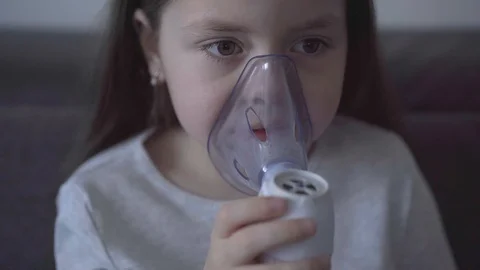 Child with asthma problems making inhalation with mask on face Stock Footage 127627083