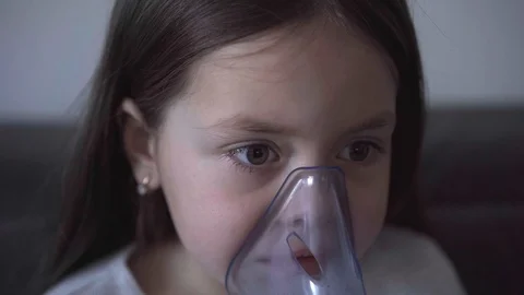 Child with asthma problems making inhalation with mask on face Stock Footage 127627102
