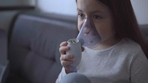 Child with asthma problems making inhalation with mask on face Stock Footage 127627107