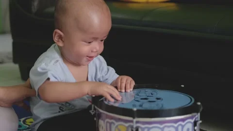 Child baby boy playing with drum toys. funny expression of little baby Stock Footage 201208804