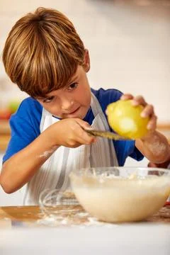 Child, baking and boy in kitchen with lemon for learning, growth and develo.. Stock Photos