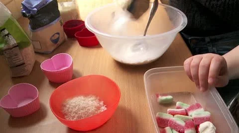 Child baking with mum, adding sweets Stock Footage 10775464