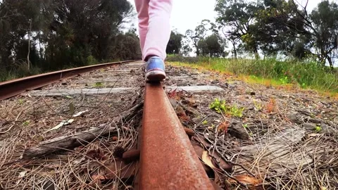 Child balancing on a train track Video stock 138614821
