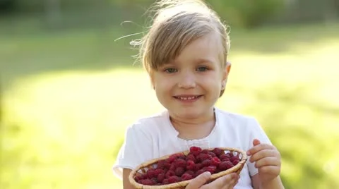 Child with basket of raspberry outdoors Stock Footage 11317076