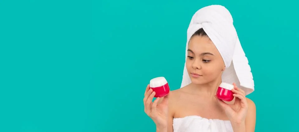 Child in bath tower choose face cream, skincare. Cosmetics and skin care for Stock Photos