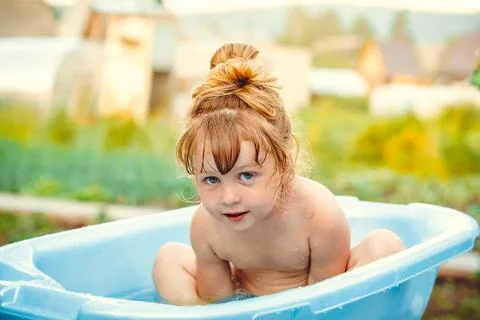 The child is bathed in a bath Stock Photos