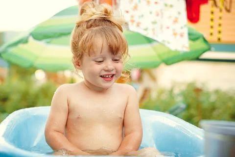 The child is bathed in a bath Stock Photos