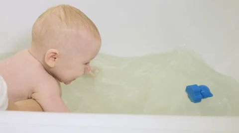 Child bathes in bath Stock Footage 62392944