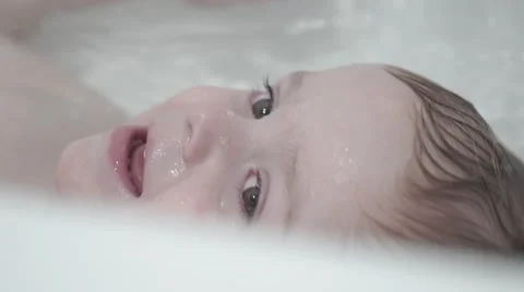 The child bathes in a bathroom Stock Footage 62179341