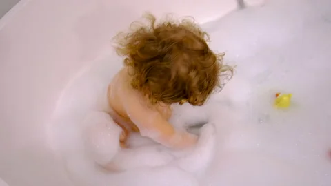 A child bathes in a bubble bath. Selective focus. Stock Footage 233605675