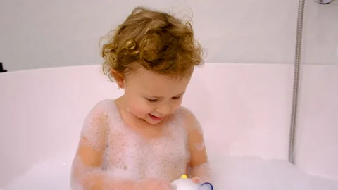 A child bathes in a bubble bath. Selective focus. Stock Footage 233606921