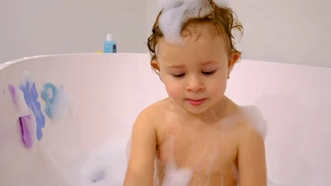 A child bathes in a bubble bath. Selective focus. Stock Footage 233687630