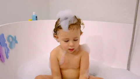 A child bathes in a bubble bath. Selective focus. Stock Footage 233829365