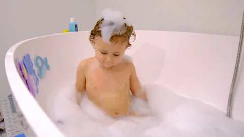A child bathes in a bubble bath. Selective focus. Stock Footage 234484788