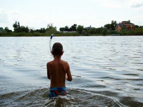 A child bathes in the river Stock Photos