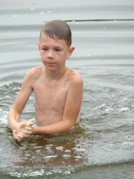 Child is bathing in the river Stock Photos