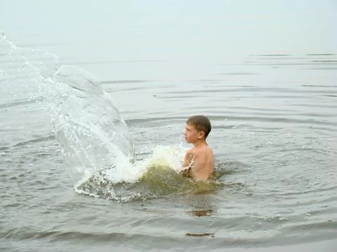 Child is bathing in the river Stock Photos