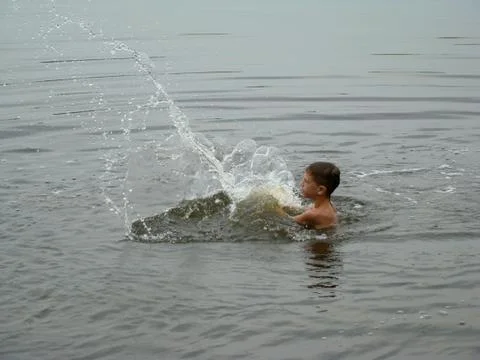 Child is bathing in the river Stock Photos