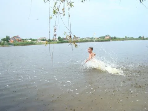 Child is bathing in the river Stock Photos