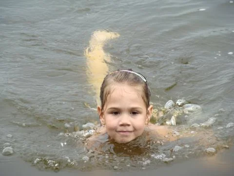Child is bathing in the river Stock Photos