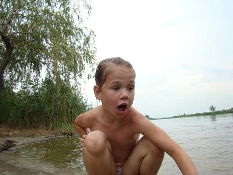 Child is bathing in the river Stock Photos