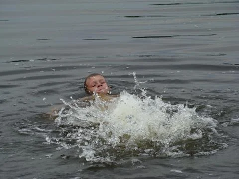 Child is bathing in the river Stock Photos