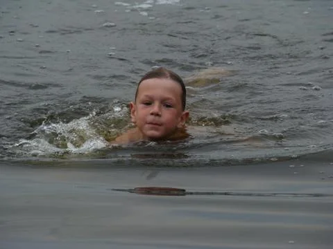 Child is bathing in the river Stock Photos