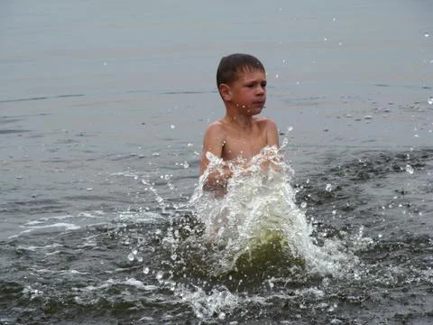 Child is bathing in the river Stock Photos