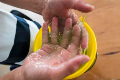Child baths his hands in thick phlegm Stock Photos