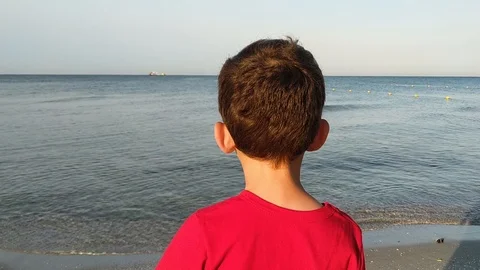 Child on the beach looking on the sea Stock Footage 112753947
