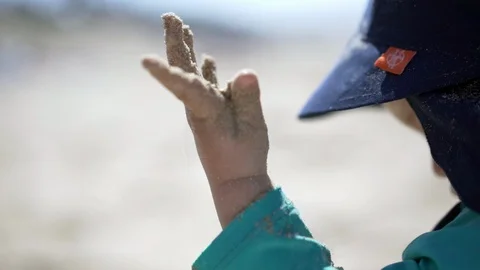 Child on a beach, playing with the sand - slow motion Stock Footage 95937098