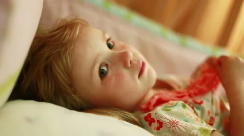 Child in bed. Look at camera. Stock Footage 5501336