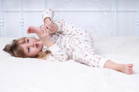 Child on the bed Stock Photos