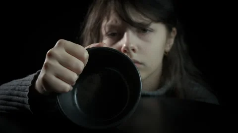 Child beggar with empty bowl Stock Footage 295697957