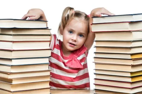 Child between the stacks of books Stock Photos