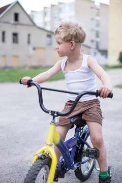 Child on a bicycle at asphalt road. Childhood. Sport. Cycling Stock Photos