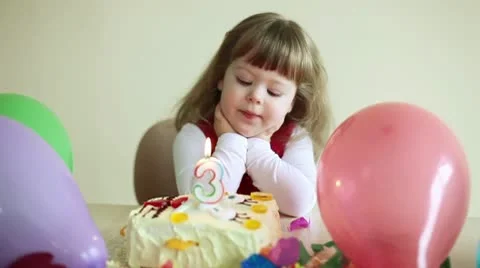 Child with a birthday cake looking at camera Stock Footage 10077850