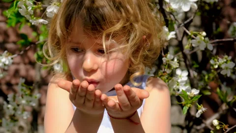 Child in a blooming garden in spring. Selective focus. Stock Footage 317401994