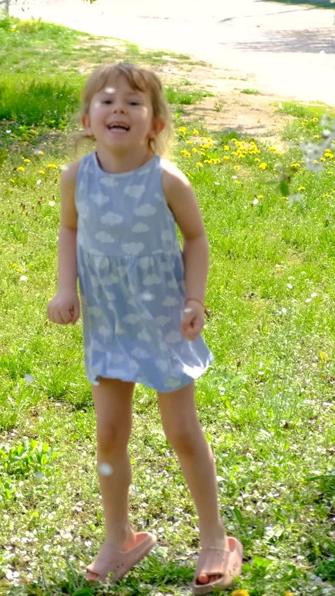 Child in a blooming garden in spring. Selective focus. Stock Footage 317889968