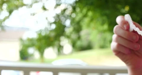 Child blowing bubbles having fun outside on a summer day close up Stock Footage 207339680