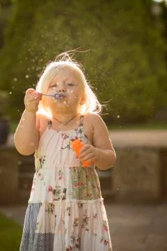 Child blowing bubbles Stock Photos