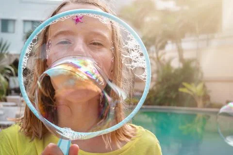 Child  blowing soap bubbles Stock Photos