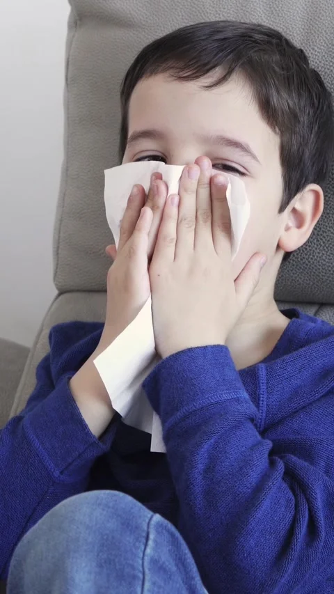 Child blowing in a wipe suffering flu Видео 335240909