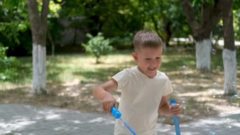 A child blows soap bubbles. Stock Footage 302800384