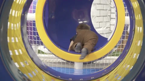 Child in a blue pipe Stock Footage 148261056